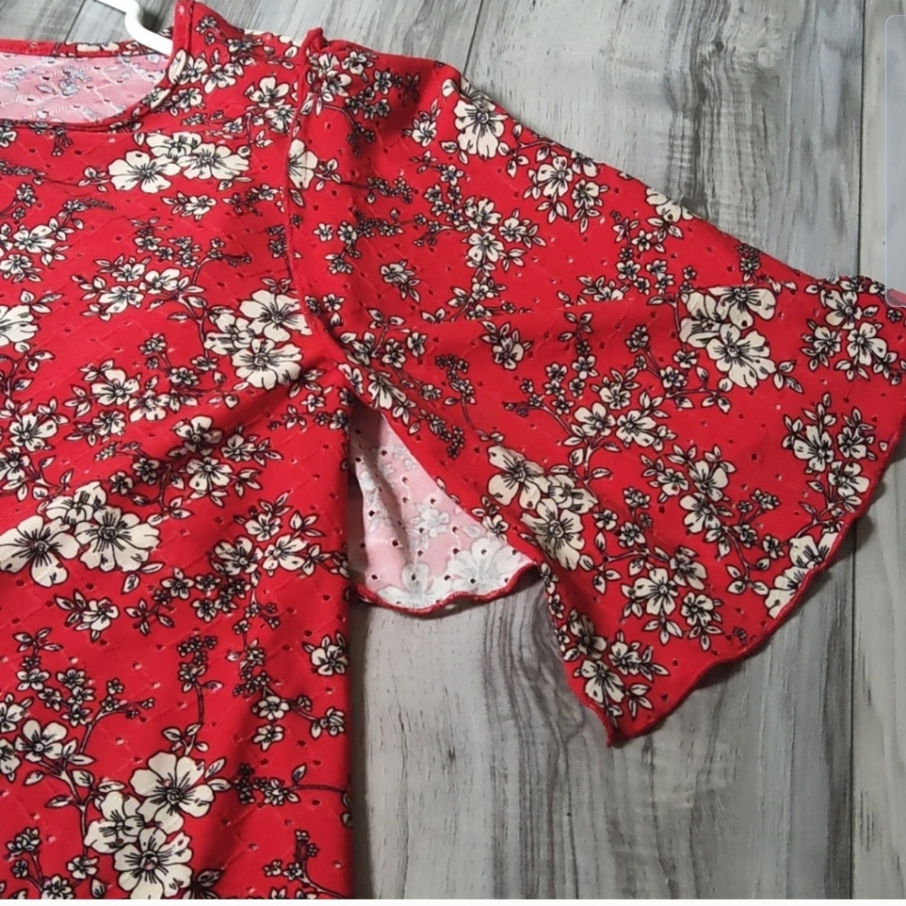 Red stretch eyelet knit floral top with beautiful flowy sleeves!